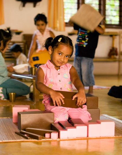 a primary child in her environment; the one carrying a 'box' is that child in this story.